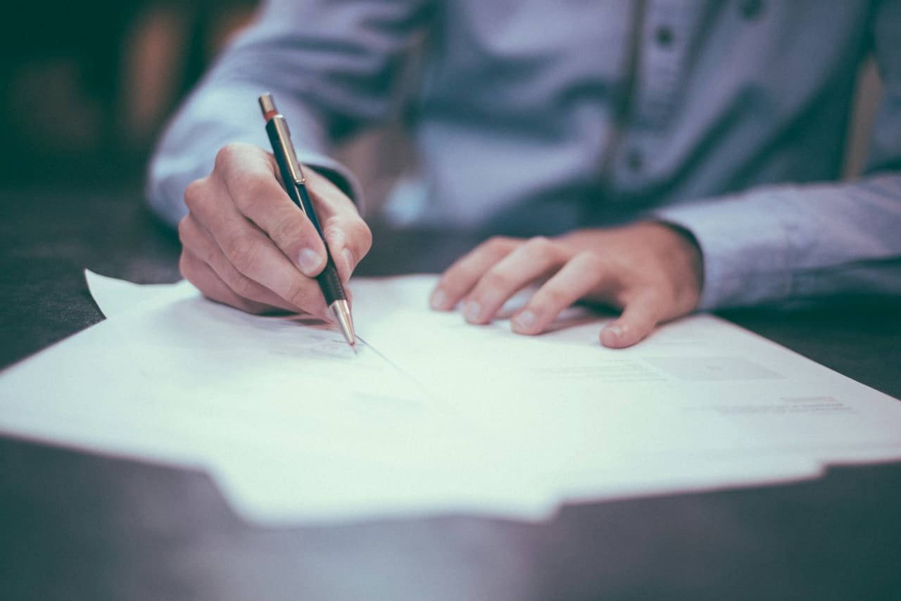 A family at a kitchen table organizing important papers and planning together